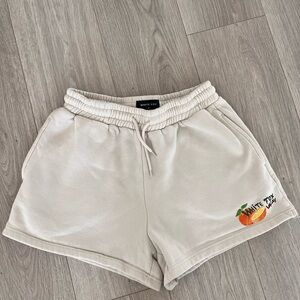 White Fox Boutique Cream Athletic Logo Shorts with Orange Graphic